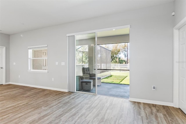 unfurnished living room featuring baseboards and wood finished floors