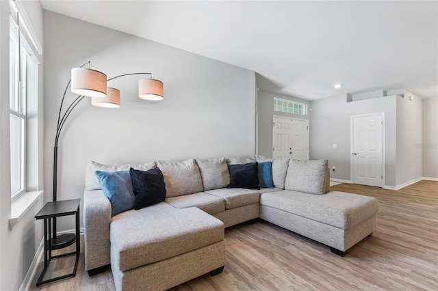 living room featuring recessed lighting, wood finished floors, and baseboards