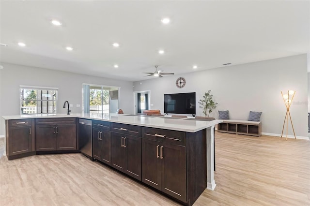 kitchen with recessed lighting, stainless steel dishwasher, light wood-style flooring, and light countertops