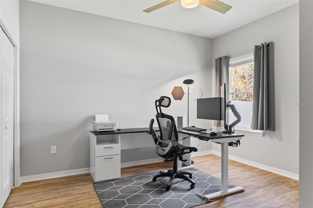 office space with ceiling fan, baseboards, and wood finished floors