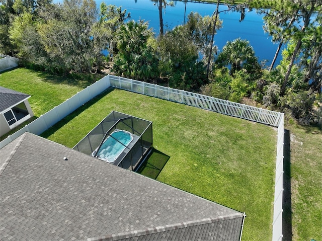 view of yard with a water view and a fenced backyard