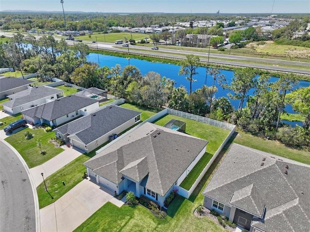 birds eye view of property with a residential view and a water view