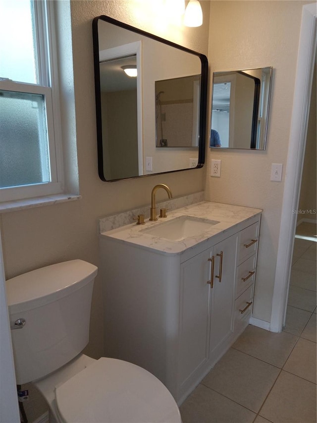 bathroom featuring tile patterned floors, toilet, and vanity