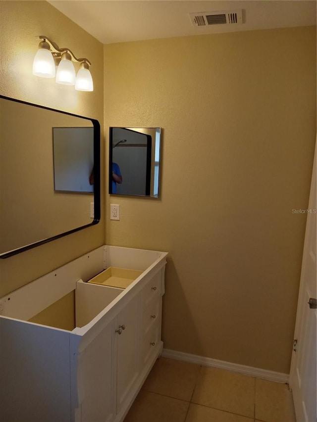 bathroom featuring vanity, tile patterned floors, baseboards, and visible vents