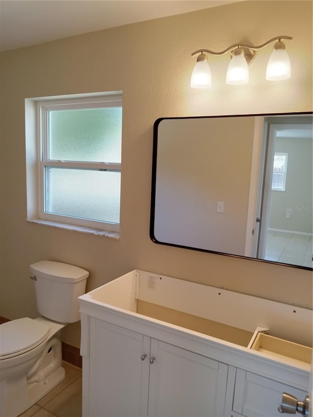 bathroom with toilet and tile patterned flooring