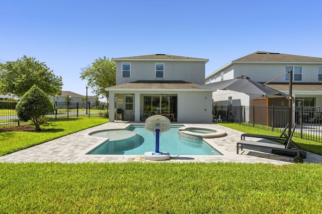 rear view of property featuring stucco siding, a lawn, a pool with connected hot tub, fence, and a patio area