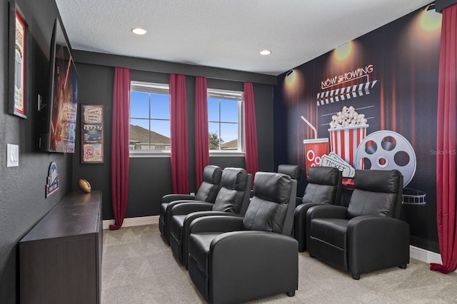 carpeted home theater room with recessed lighting, a textured ceiling, and baseboards