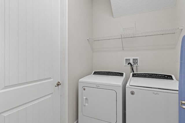 clothes washing area featuring laundry area and washer and dryer