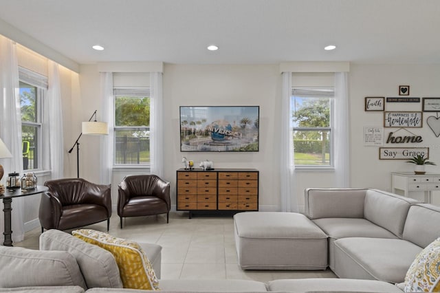 living area with light tile patterned floors, a healthy amount of sunlight, and recessed lighting