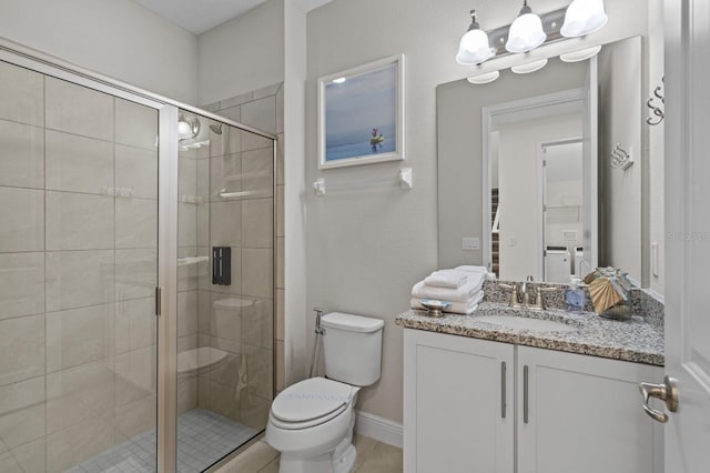 full bathroom with vanity, baseboards, tile patterned flooring, a shower stall, and toilet