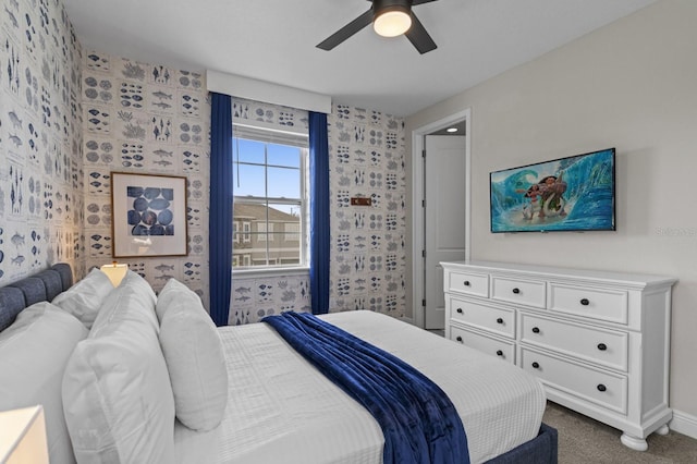 bedroom with baseboards, dark carpet, and ceiling fan