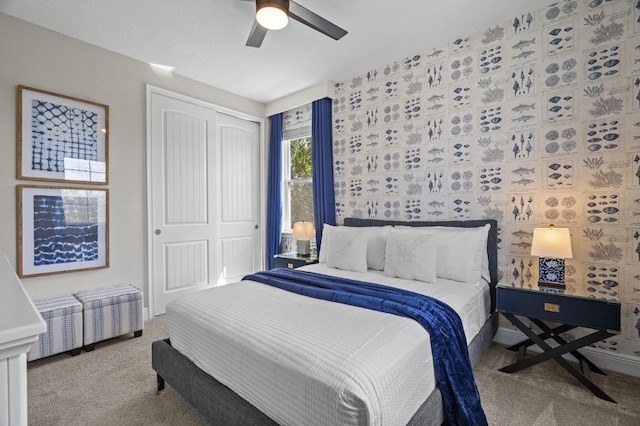 carpeted bedroom with a closet and a ceiling fan