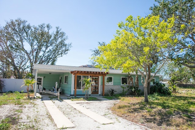 view of front of property featuring a carport and fence