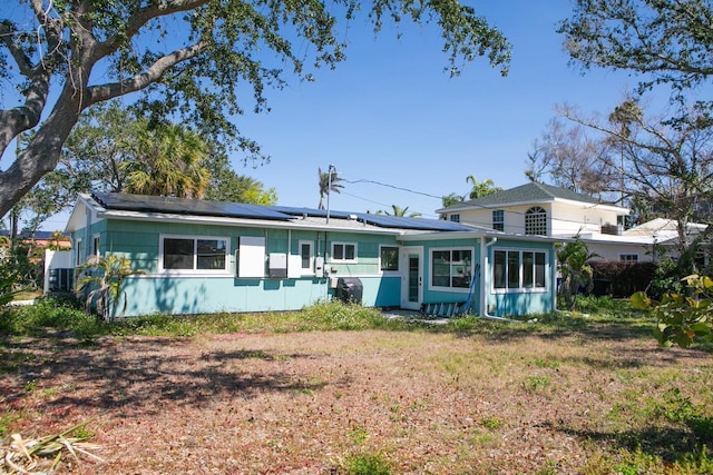 ranch-style home with solar panels