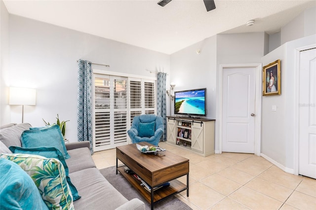 living area featuring light tile patterned flooring, baseboards, and a ceiling fan