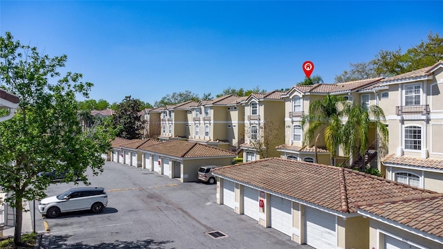 view of building exterior featuring community garages and a residential view