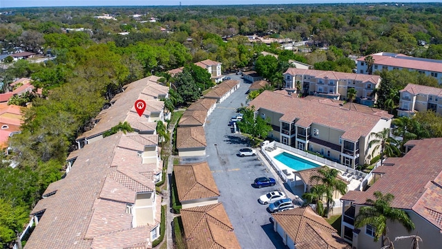 birds eye view of property with a forest view and a residential view