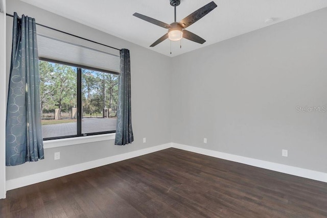 empty room with wood finished floors, baseboards, and ceiling fan