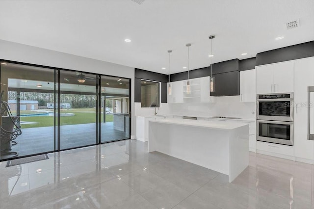 kitchen featuring visible vents, modern cabinets, white cabinetry, double oven, and light countertops