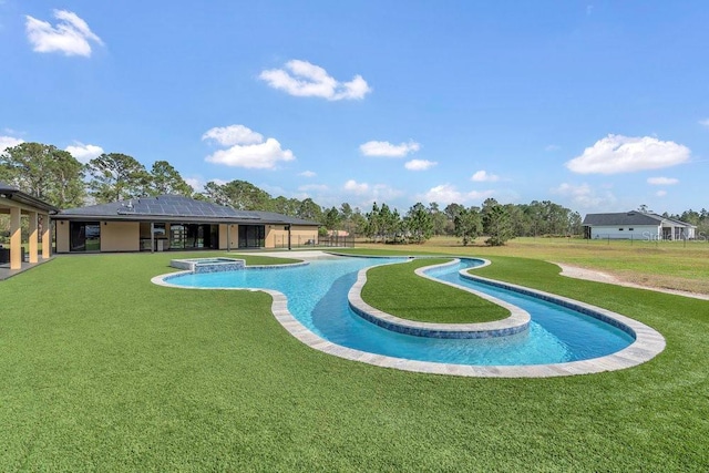 view of swimming pool featuring a patio, a lawn, and a pool with connected hot tub