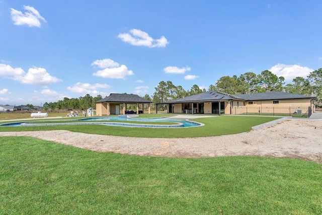 surrounding community with a lawn and fence