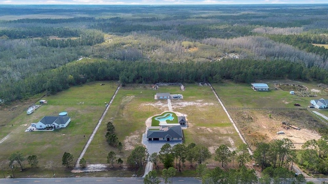 aerial view featuring a rural view and a wooded view