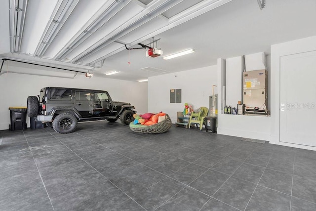 garage with electric panel, heating unit, and a garage door opener