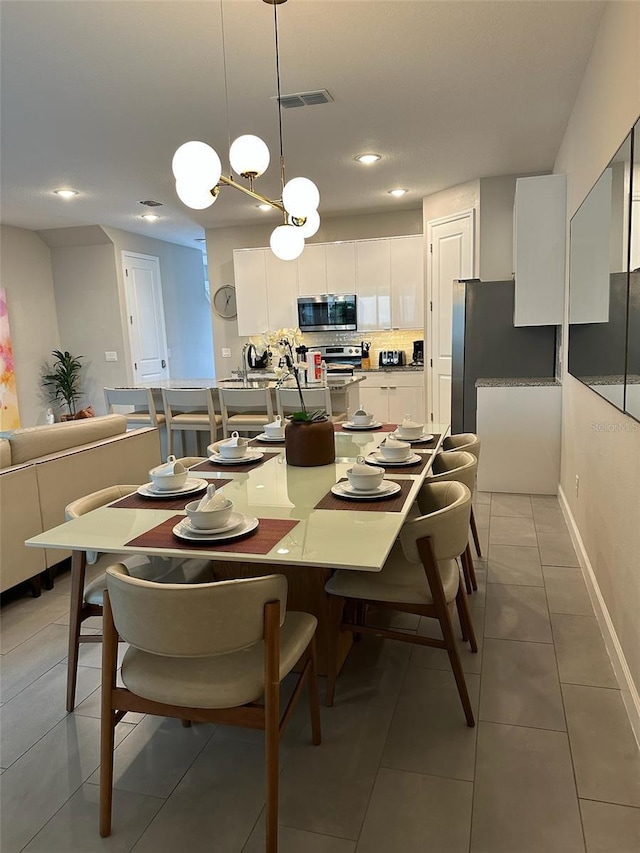 dining area with light tile patterned floors, recessed lighting, visible vents, and baseboards