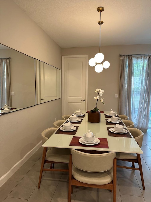 dining area featuring light tile patterned floors and baseboards