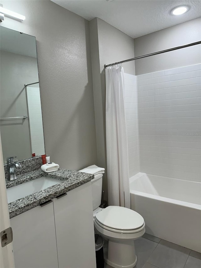 full bathroom with vanity, tile patterned flooring, a textured ceiling, toilet, and shower / tub combo with curtain