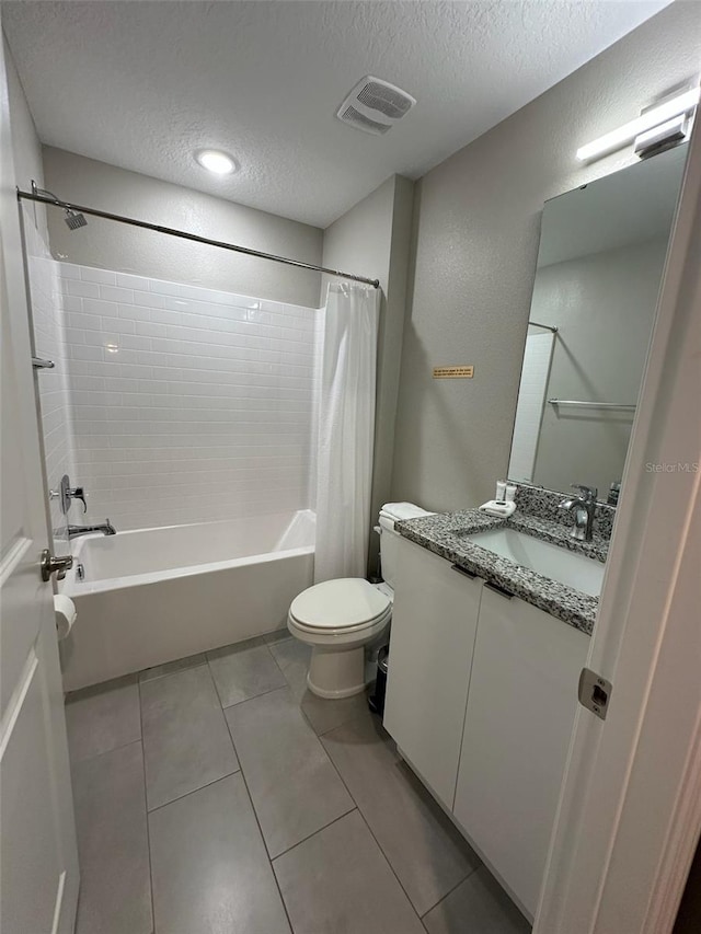 full bath featuring visible vents, toilet, shower / tub combo with curtain, a textured ceiling, and tile patterned flooring