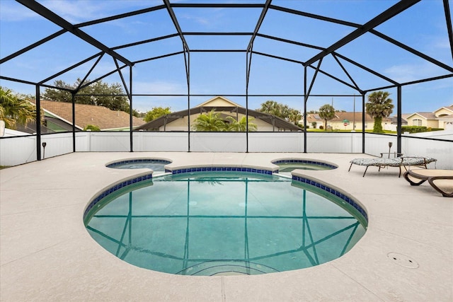 view of swimming pool with a patio, a lanai, and a pool with connected hot tub