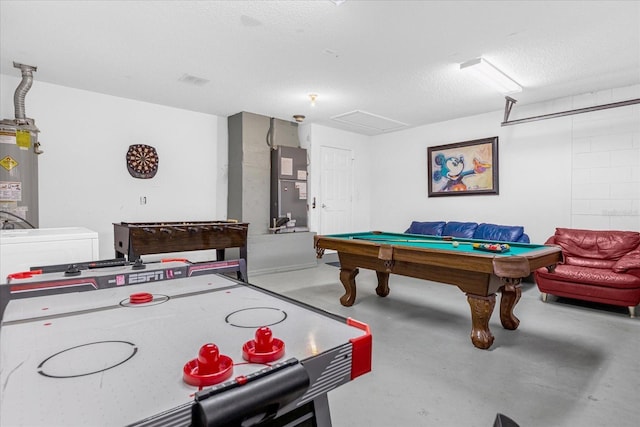 recreation room with concrete flooring, water heater, heating unit, a textured ceiling, and billiards