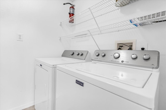 laundry area with washer and dryer, baseboards, and laundry area