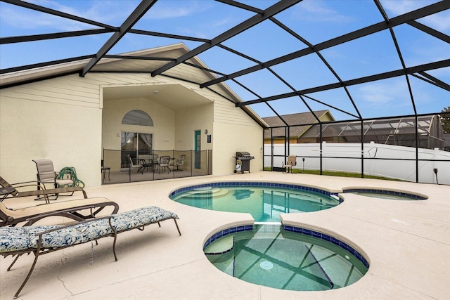 view of pool featuring a patio area, a pool with connected hot tub, a grill, and a lanai