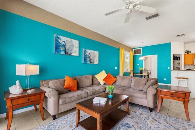 229 Troon Cir, Davenport, FL 33897 - living room with light tile patterned floors, a ceiling fan, and an accent wall