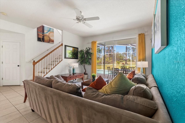 229 Troon Cir, Davenport, FL 33897 - living room featuring light tile patterned floors, a ceiling fan, stairway, and a textured ceiling