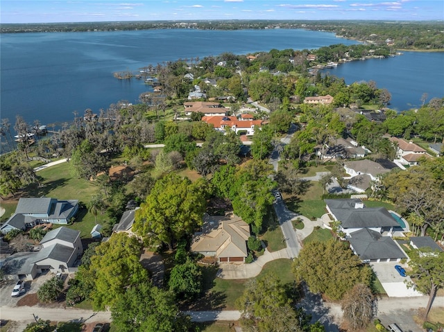 drone / aerial view with a water view and a residential view