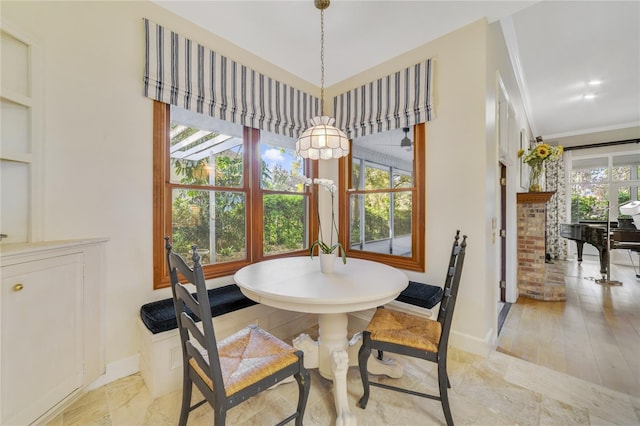 dining room featuring crown molding and baseboards