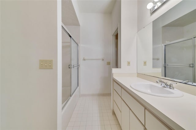 full bath featuring tile patterned floors, vanity, enclosed tub / shower combo, and baseboards