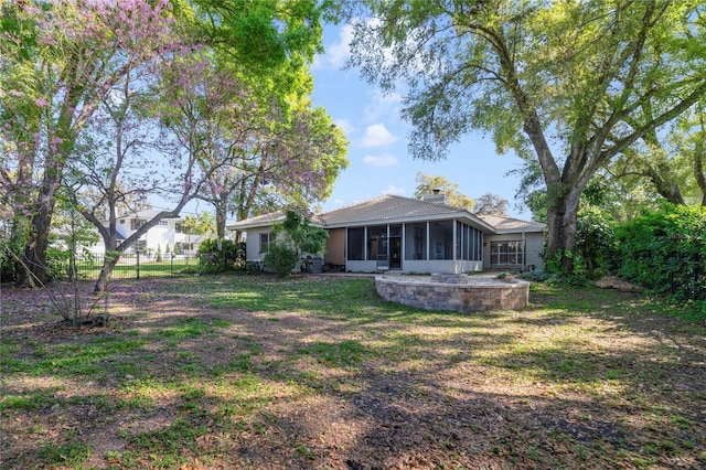 view of yard with fence and a sunroom