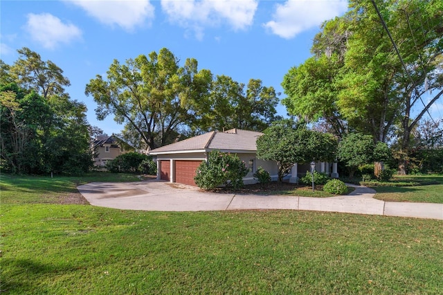 view of front of house with a front yard, a garage, and driveway