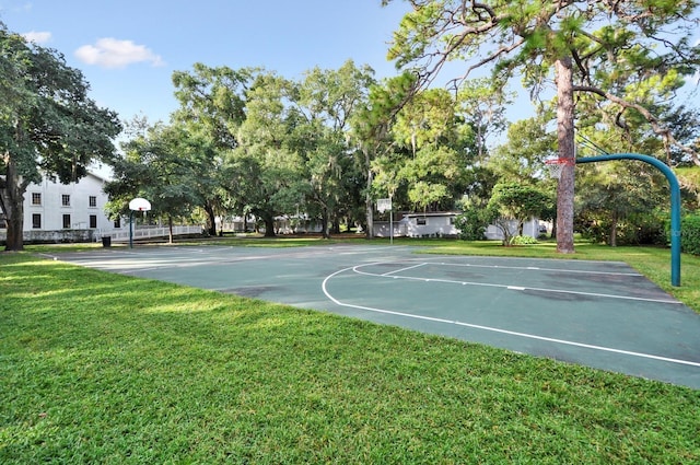 view of sport court with a lawn and community basketball court