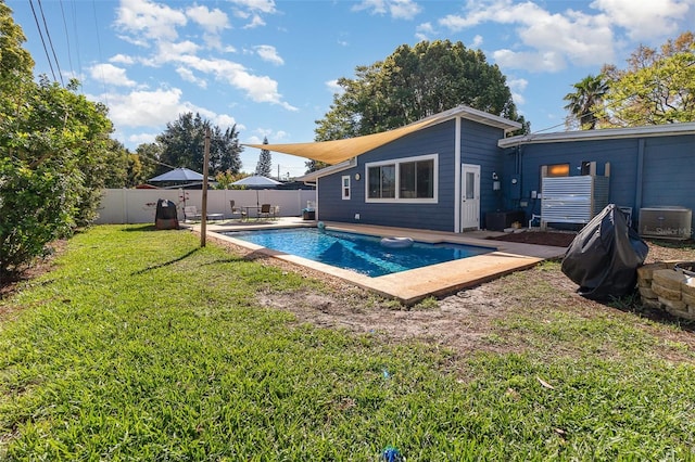 view of swimming pool with a fenced in pool, a patio, a lawn, and a fenced backyard