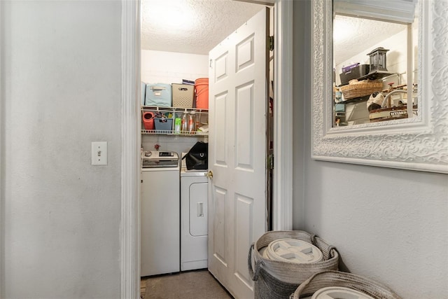 laundry area featuring laundry area, a textured wall, independent washer and dryer, and a textured ceiling