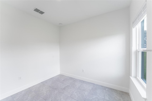 spare room with visible vents and baseboards