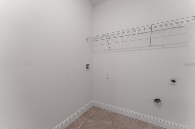 washroom featuring light tile patterned floors, baseboards, hookup for an electric dryer, hookup for a washing machine, and laundry area