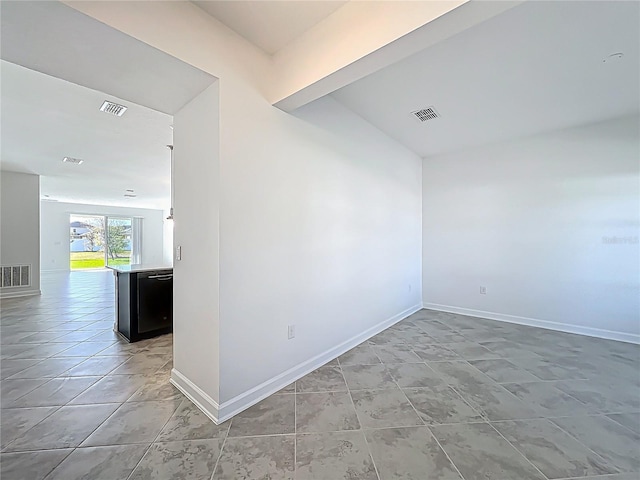 empty room featuring baseboards and visible vents