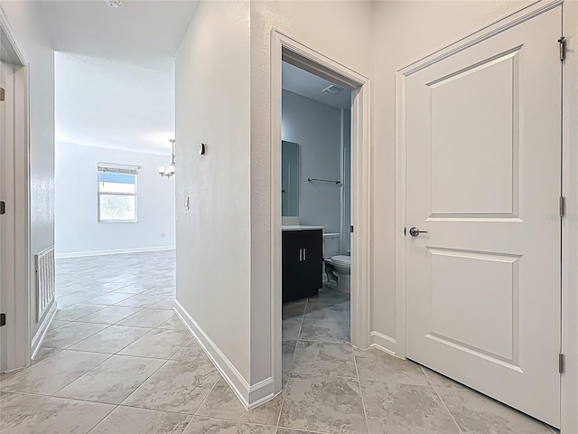 corridor featuring visible vents and baseboards