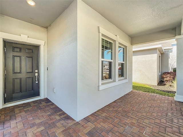 property entrance featuring stucco siding